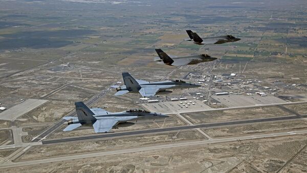 F-35C Lightning IIs, attached to the Grim Reapers of Strike Fighter Squadron (VFA) 101, and an F/A-18E/F Super Hornets attached to the Naval Aviation Warfighter Development Center (NAWDC) fly over Naval Air Station Fallon (NASF).  - Sputnik International