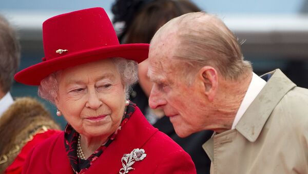 Britain's Queen Elizabeth speaks to her husband Prince Philip as they attend the official re-opening of the Cutty Sark in Greenwich, London  April 25, 2012. - Sputnik International