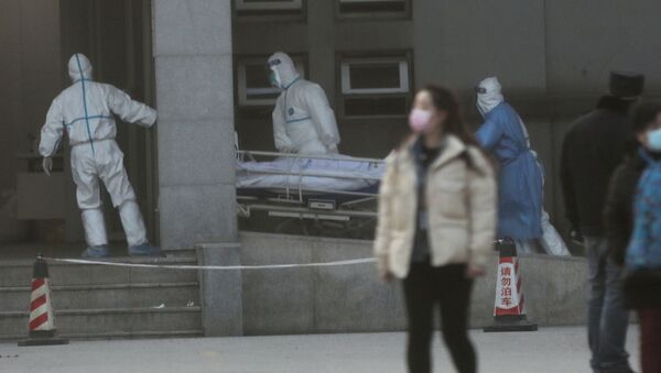 Medical staff transfer a patient at the Jinyintan hospital, where the patients with pneumonia caused by the new strain of coronavirus are being treated, in Wuhan, Hubei province, China January 20, 2020 - Sputnik International