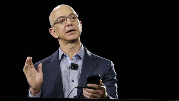FILE - In a June 18, 2014 file photo, Amazon CEO Jeff Bezos demonstrates the new Amazon Fire Phone during a launch event, in Seattle. Blue Origin, LLC in Van Horn, Texas, the brainchild of Amazon founder Bezos, is one of two parts of the 21st-century space race being directed in the Texas by Internet billionaires - Sputnik International