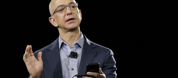 FILE - In a June 18, 2014 file photo, Amazon CEO Jeff Bezos demonstrates the new Amazon Fire Phone during a launch event, in Seattle. Blue Origin, LLC in Van Horn, Texas, the brainchild of Amazon founder Bezos, is one of two parts of the 21st-century space race being directed in the Texas by Internet billionaires - Sputnik International
