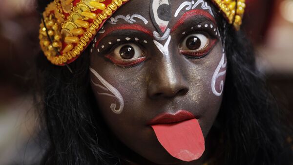 In this Friday, April 13, 2018, file photo, a girl dressed as Hindu goddess Kali waits to join a religious procession during a ritual of Shiva Gajan Hindu festival in Kolkata, India - Sputnik International