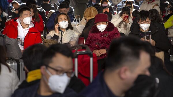 Travelers wear face masks as they sit in a waiting room at the Beijing West Railway Station in Beijing, Tuesday, Jan. 21, 2020 - Sputnik International