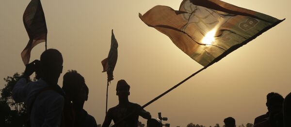 Supporters of India's ruling Bharatiya Janata Party (BJP) cheer with party flags as they attend an election rally addressed by Indian Prime Minister Narendra Modi, in Mathurapur, south of Kolkata, India, Thursday, May 16, 2019. Supporters of India's ruling Bharatiya Janata Party (BJP) cheer with party flags as they attend an election rally addressed by Indian Prime Minister Narendra Modi, in Mathurapur, south of Kolkata, India, Thursday, May 16, 2019. - Sputnik International