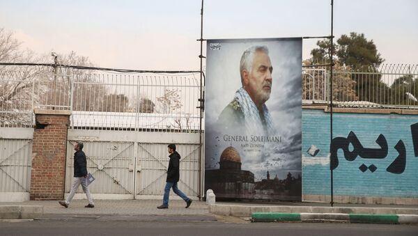 People walk past a picture of Iranian Major-General Qassem Soleimani, head of the elite Quds Force, who was killed in an air strike at Baghdad airport, as it is seen in front of the former U.S. Embassy's building in Tehran, Iran, January 21, 2020 - Sputnik International