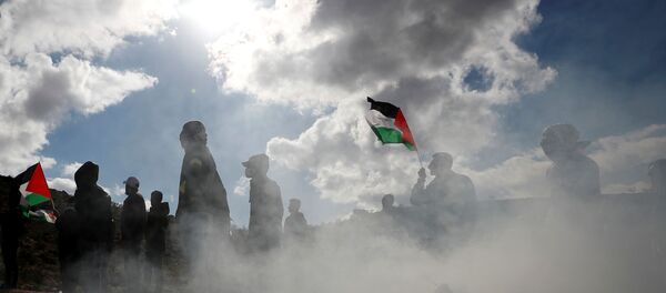 Palestinian demonstrators take part in an anti-Israel protest in al-Mughayyir village near Ramallah, in the Israeli-occupied West Bank, January 3, 2020.  - Sputnik International