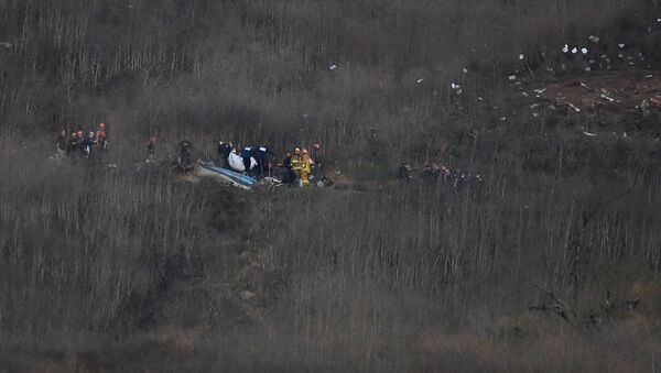 Jan 26, 2020; Calabasas, California, USA;  Members of LA County Fire and LA County corners begin the task of removing bodies from the hillside where the helicopter carrying Kobe Bryant and 8 others crashed in Calabasas, CA - Sputnik International