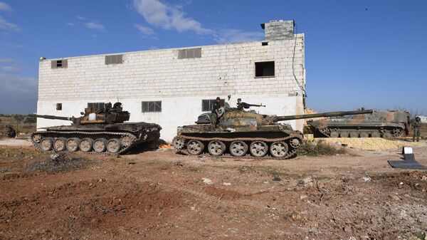 Tanks of Syrian army are seen during the liberation of the Jarjanaz town from the militants, northwestern province of Idlib, Syria. Due to the location of Jarjanaz, this will enable the army to take control over the important Hama-Aleppo road in Idlib, which remains a terrorist stronghold. - Sputnik International