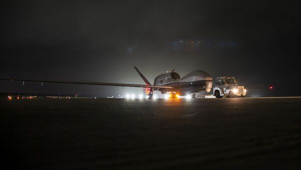 An MQ-4C Triton unmanned aircraft system (UAS) idles on a runway at Andersen Air Force Base after arriving for a deployment as part of an early operational capability (EOC) test to further develop the concept of operations and fleet learning associated with operating a high-altitude, long-endurance system in the maritime domain.  - Sputnik International