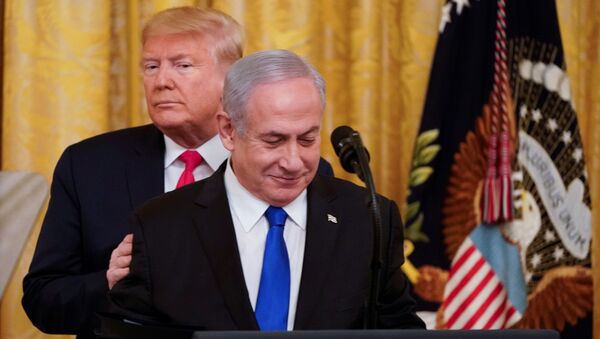 U.S. President Donald Trump puts his hands on Israel's Prime Minister Benjamin Netanyahu's shoulders as they deliver joint remarks on a Middle East peace plan proposal in the East Room of the White House in Washington, U.S., January 28, 2020. - Sputnik International