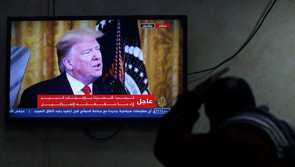 A Palestinian man watches a television screen broadcasting the announcement of Mideast peace plan by U.S. President Donald Trump - Sputnik International