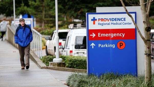 A man walks by the Providence Regional Medical Center campus after a spokesman from the U.S. Centers for Disease Control and Prevention (CDC) said a traveler from China has been the first person in the United States to be diagnosed with the Wuhan coronavirus, in Everett, Washington, U.S. January 21, 2020 - Sputnik International