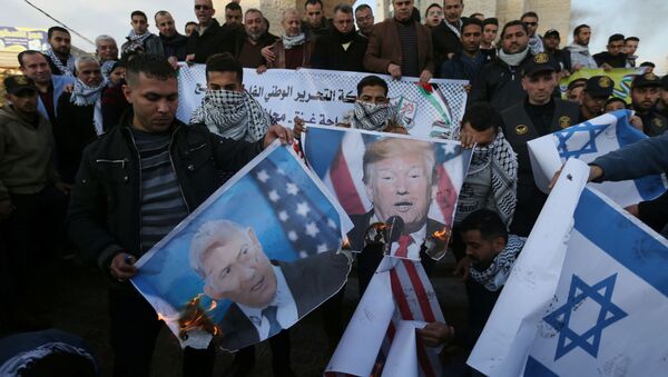Palestinian demonstrators burn pictures depicting U.S. President Donald Trump and Israeli Prime Minister Benjamin Netanyahu, and repsentations of U.S and Israeli flags during a protest against the U.S. President Donald Trump's Middle East peace plan, in the southern Gaza Strip January 29, 2020 - Sputnik International