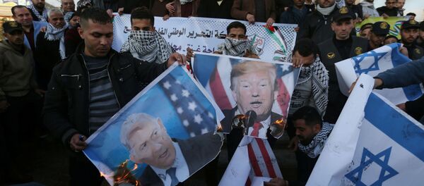 Palestinian demonstrators burn pictures depicting U.S. President Donald Trump and Israeli Prime Minister Benjamin Netanyahu, and repsentations of U.S and Israeli flags during a protest against the U.S. President Donald Trump's Middle East peace plan, in the southern Gaza Strip January 29, 2020 - Sputnik International