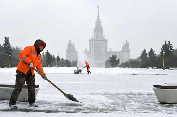City service workers clean snow near the Moscow State University building - Sputnik International