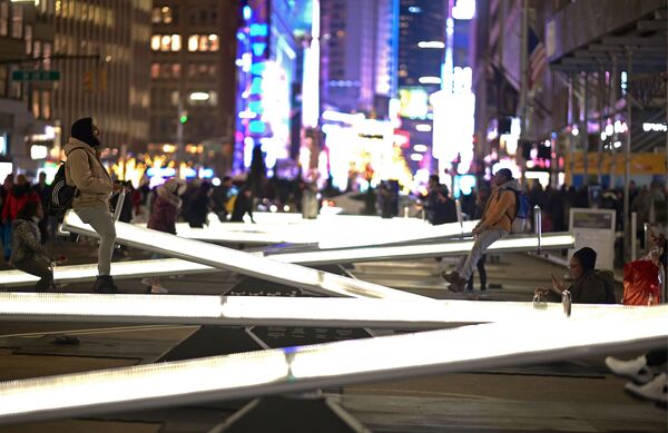 People play on an installation called Impulse,, twelve glowing seesaws, located on Broadway close to Time Square on January 29, 2020 in New York City.  - Sputnik International