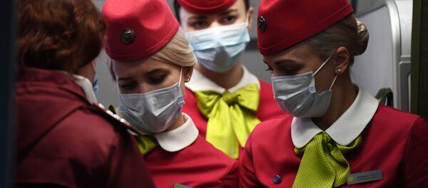 Flight attendants wearing face masks on board a S7 Airlines flight which arrived from Beijing to Novosibirsk Flight attendants wearing face masks on board a S7 Airlines flight which arrived from Beijing to Novosibirsk - Sputnik International