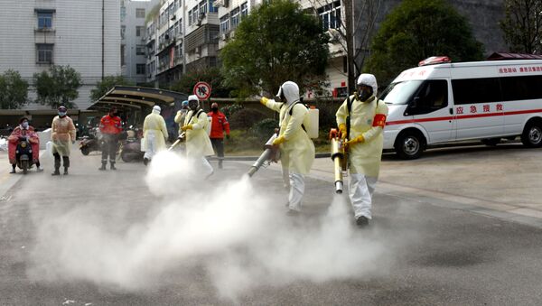 Volunteers in protective suits disinfect a residential compound, as the country is hit by the outbreak of a new coronavirus, in Taizhou, Zhejiang province, China January 30, 2020 - Sputnik International
