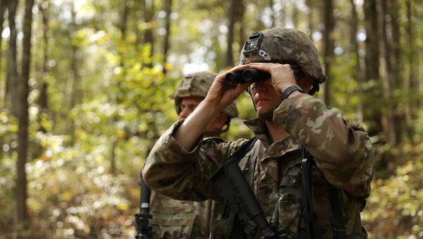 U.S Army Sgt. Nicholas Wallace uses binoculars to scan the wooded area for possible threats during the 2019 HQDA Best Warrior Competition at Fort A.P. Hill, Virginia, Oct. 6, 2019 - Sputnik International