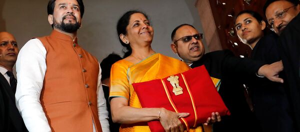 India's Finance Minister Nirmala Sitharaman is flanked by junior Finance Minister Anurag Thakur as she arrives to present the budget in Parliament in New Delhi, India, February 1, 2020.  - Sputnik International