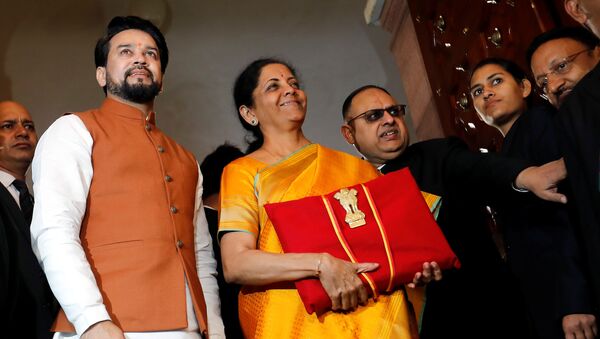India's Finance Minister Nirmala Sitharaman is flanked by junior Finance Minister Anurag Thakur as she arrives to present the budget in Parliament in New Delhi, India, February 1, 2020.  - Sputnik International