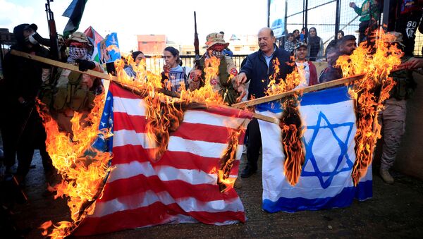Demonstrators set fire to a makeshift Israeli and U.S. flag during a protest against U.S. President Donald Trump's Middle East peace plan, in Ain al-Hilweh Palestinian refugee camp, near Sidon, Lebanon January 29, 2020 - Sputnik International
