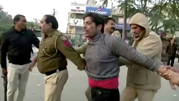 Police officers detain a man, who identified himself as Kapil Gujjar, who fired multiple shots at a site where people were protesting against a new citizenship law in New Delhi, India, February 1, 2020, in this still image taken from video - Sputnik International