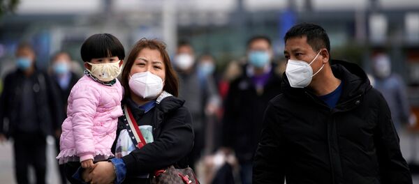 Passengers wearing masks walk outside the Shanghai railway station in Shanghai, China, as the country is hit by an outbreak of a new coronavirus, February 2, 2020. - Sputnik International