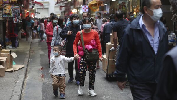 People visit the open market wearing face masks in hopes to prevent contracting the spreading coronavirus in Hong Kong - Sputnik International
