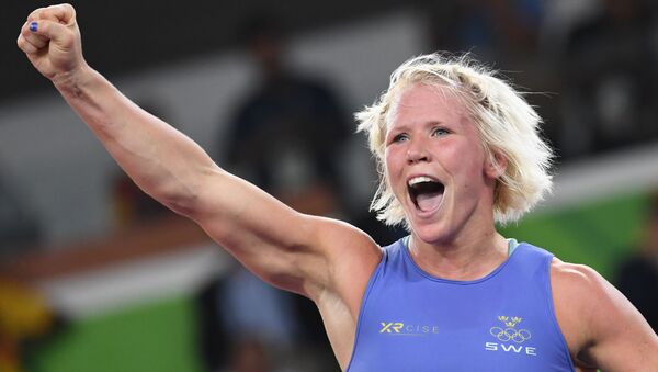 Sweden's Anna Jenny Fransson (blue) celebrates after winning against Canada's Dorothy Erzsebet Yeats in their women's 69kg freestyle bronze medal match on August 17, 2016, during the wrestling event of the Rio 2016 Olympic Games at the Carioca Arena 2 in Rio de Janeiro - Sputnik International