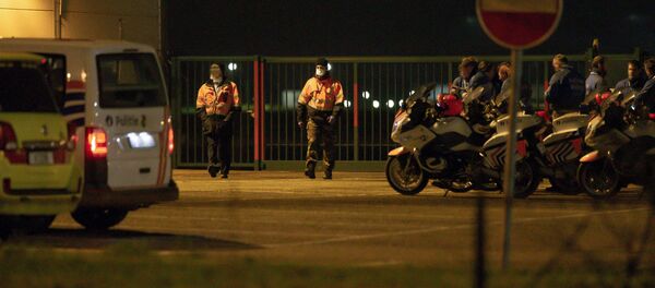 Security personnel walk near the tarmac during the arrival of a plane carrying Belgian and European citizens repatriated from the coronavirus hot-zone in Wuhan, at the military airport in Melsbroek, on 2 February 2020. - A second plane chartered by Paris to bring back 250 people from Wuhan, including 65 French, landed in the afternoon of 2 February in Istres, where some of them, including the French, will be placed in quarantine. The A380 was then to take off for Belgium, according to a diplomatic source in Brussels. The aircraft will then take Belgian nationals of other nationalities to Melsbroek military airport, according to the same source. - Sputnik International