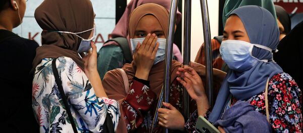 Passengers wear masks to prevent the outbreak of a new coronavirus in a Light Rail Transit train in Kuala Lumpur, Malaysia, January 31, 2020 Passengers wear masks to prevent the outbreak of a new coronavirus in a Light Rail Transit train in Kuala Lumpur, Malaysia, January 31, 2020 - Sputnik International