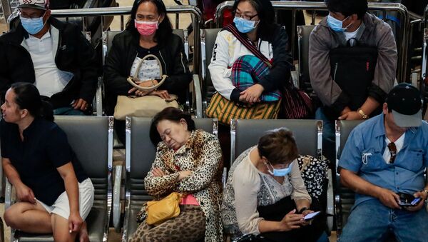 Passengers wait at the departure area while wearing protective masks, following confirmed cases of coronavirus in the country, at Ninoy Aquino International Airport, in Manila, Philippines, 5 February 2020. - Sputnik International