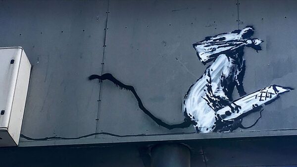 An artwork depicting a masked rat by British street-artist Banksy on the back of a parking sign in Paris - Sputnik International