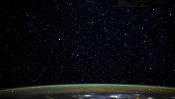 This NASA image obtained on January 5, 2020 shows stars as they glitter in the night sky above the Earth's atmospheric glow - Sputnik International