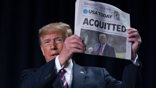 President Donald Trump holds up a newspaper with the headline that reads ACQUITTED at the 68th annual National Prayer Breakfast, at the Washington Hilton, Thursday, Feb. 6, 2020, in Washington. - Sputnik International