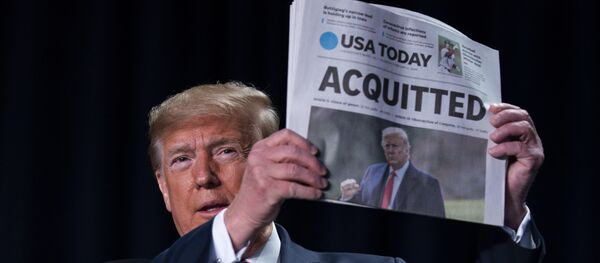 President Donald Trump holds up a newspaper with the headline that reads ACQUITTED at the 68th annual National Prayer Breakfast, at the Washington Hilton, Thursday, Feb. 6, 2020, in Washington. President Donald Trump holds up a newspaper with the headline that reads ACQUITTED at the 68th annual National Prayer Breakfast, at the Washington Hilton, Thursday, Feb. 6, 2020, in Washington. - Sputnik International