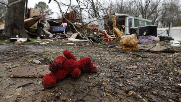 A rain soaked teddy bear lies in the front yard of the remains of Emma Carter's mobile home in Pickens, Miss., Thursday, Feb. 6, 2020. Carter and several family members lay on the living room floor and prayed as severe weather hit the area Wednesday. All survived with minor injuries. (AP Photo/Rogelio V. Solis) - Sputnik International