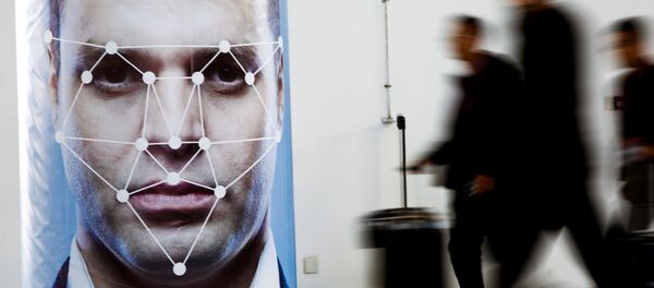 People walk past a poster simulating facial recognition software at the Security China 2018 exhibition on public safety and security in Beijing, China October 24, 2018 People walk past a poster simulating facial recognition software at the Security China 2018 exhibition on public safety and security in Beijing, China October 24, 2018 - Sputnik International