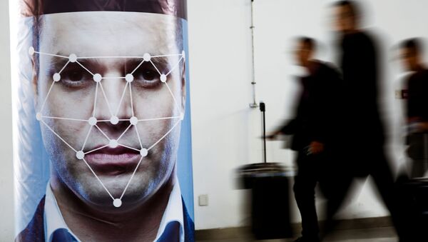 People walk past a poster simulating facial recognition software at the Security China 2018 exhibition on public safety and security in Beijing, China October 24, 2018 - Sputnik International