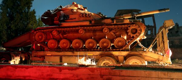 A Turkish military convoy of tanks and armoured vehicles passes through the town of Binnish reportedly heading toward the city of Idlib in Syria’s northwestern province of the same name, on February 7, 2020 - Sputnik International