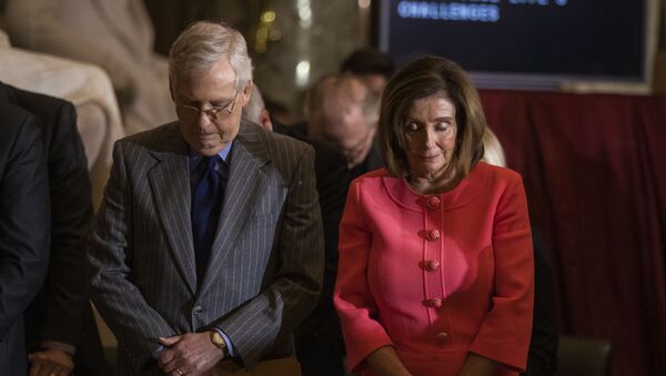 House Speaker Nancy Pelosi and Senate Majority Leader Mitch McConnell of Ky., bow their heads and pray during a Congressional Gold Medal ceremony honoring amyotrophic lateral sclerosis (ALS) advocate and former National Football League (NFL) player, Steve Gleason, in Statuary Hall on Capitol Hill, Wednesday, Jan. 15, 2020, in Washington. - Sputnik International