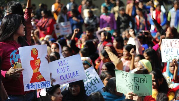 Women activists hold banners and shout slogans demanding justice in the case of a veterinarian who was gang-raped and killed last week, during a protest in New Delhi, India, Tuesday, Dec. 3, 2019 - Sputnik International