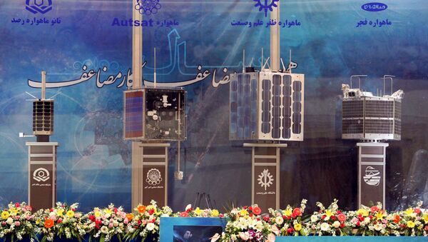 Iran's prototypes of four new satellites (from L) Rasad, Amir Kabir-1, Zafar and Fajr, are on display during their unveiling ceremony in Tehran on 7 February 2011  - Sputnik International