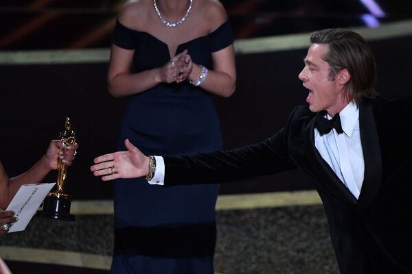 US actor Brad Pitt accepts the award for best actor in a supporting role for Once Upon a Time...in Hollywood from US actress Regina King (L) during the 92nd Oscars at the Dolby Theatre in Hollywood, California on 9 February 2020.  - Sputnik International