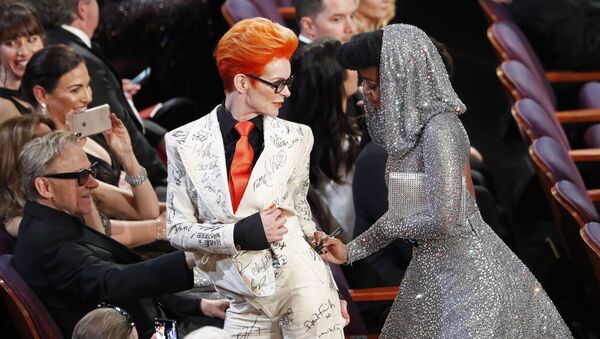 Janelle Monae signs Sandy Powell's outfit during the Oscars show at the 92nd Academy Awards in Hollywood, Los Angeles, California, U.S., February 9, 2020.  - Sputnik International