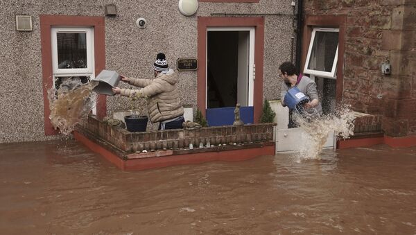 Men try to control the flow of flood water, outside a property, in Appleby-in-Westmorland, as Storm Ciara hits the UK, in Cumbria, England, Sunday Feb. 9, 2020 - Sputnik International