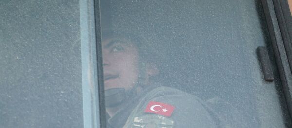 A Turkish military personnel looks out the window of a military vehicle as it enters the Bab al-Hawa crossing at the Syrian-Turkish border, in Idlib governorate, Syria, February 9, 2020 A Turkish military personnel looks out the window of a military vehicle as it enters the Bab al-Hawa crossing at the Syrian-Turkish border, in Idlib governorate, Syria, February 9, 2020 - Sputnik International