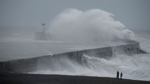 Waves crash over the harbour wall by a lighthouse as Storm Ciara hits Newhaven, on the south coast of England, Sunday, Feb. 9, 2020 - Sputnik International