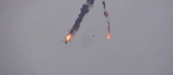 The video shows dramatic footage of the helicopter in flames going down in Idlib - Sputnik International